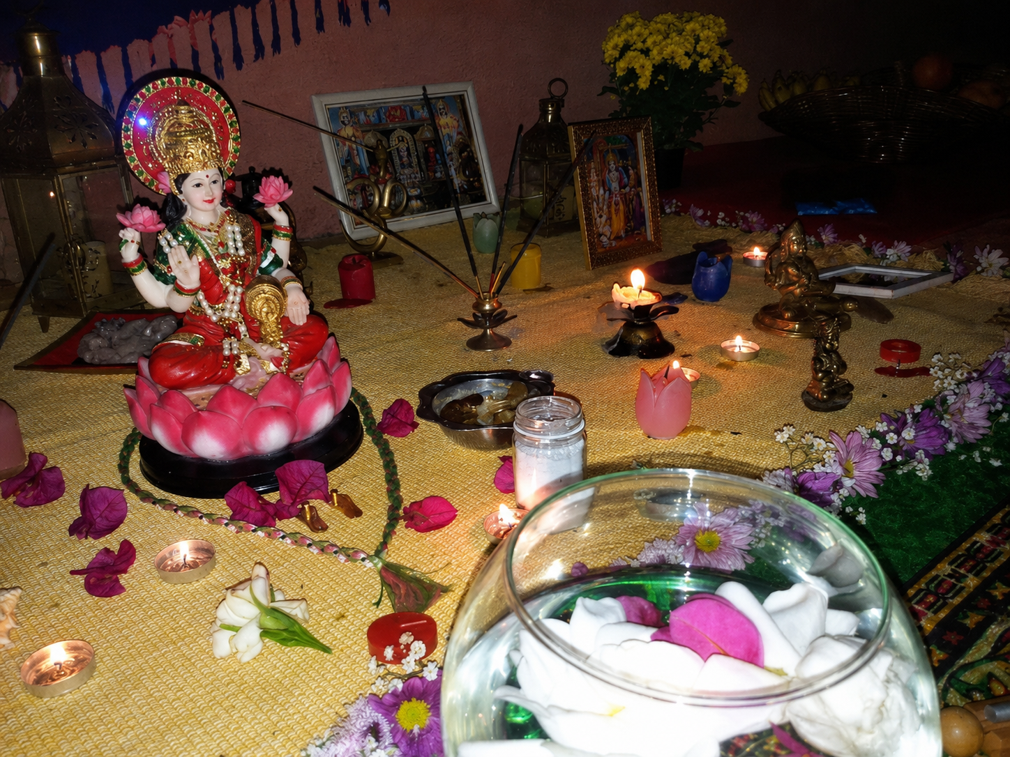 Altar de Diwali com imagem de Lakshmi, velas, flores e oferendas