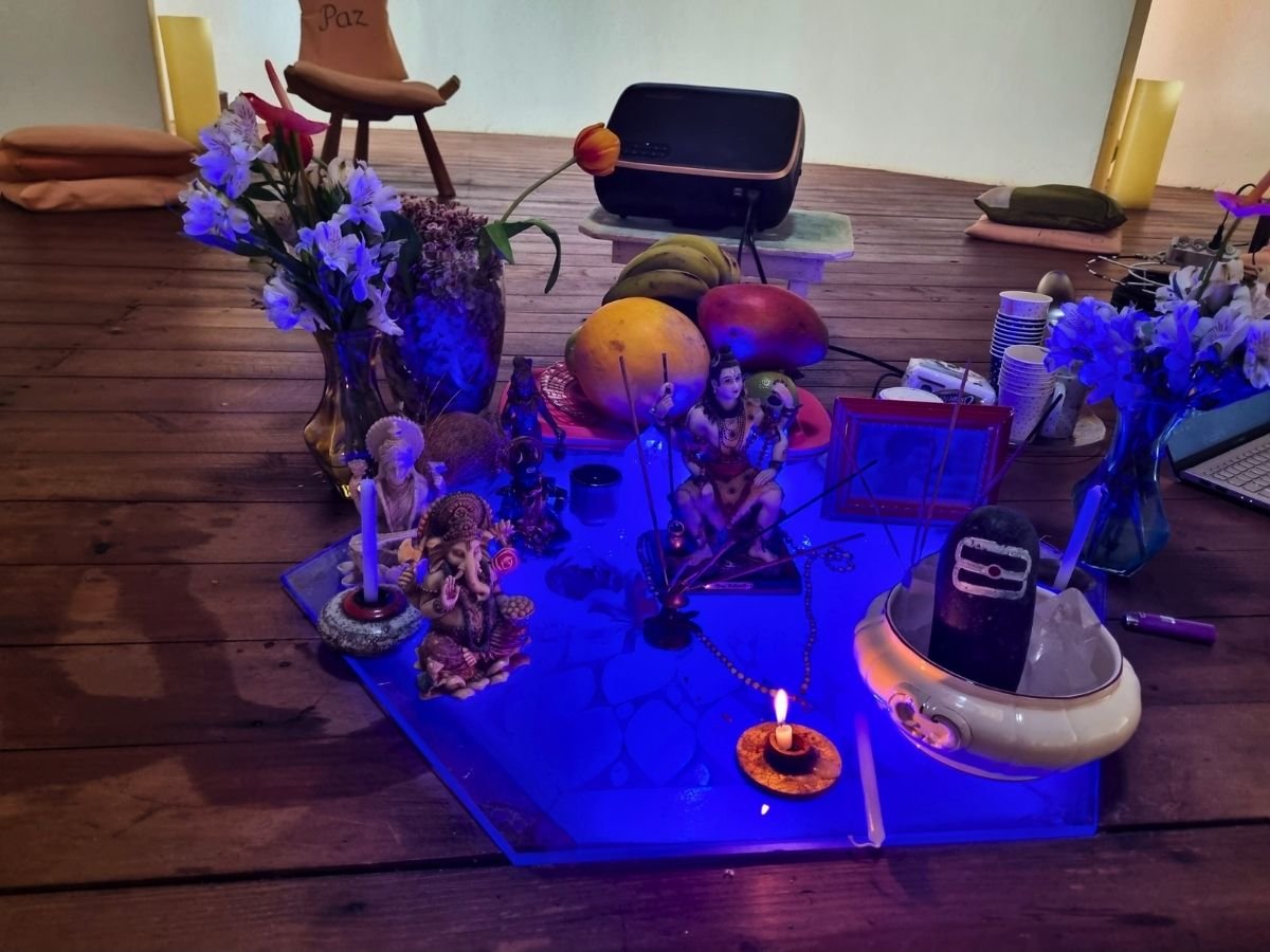 Altar do Retiro Devocional com flores, oferendas, imagens sagradas e uma chama acesa